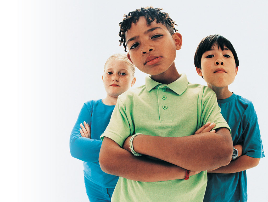 three children with arms folded
